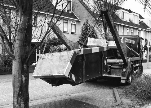 Workers loading mixed commercial waste in a town centre location